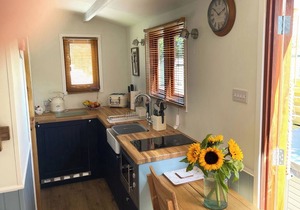 Shepherd’s Hut with an open plan design with king-size bed.