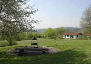 Wooden bungalow with a terrace, in a wooded area