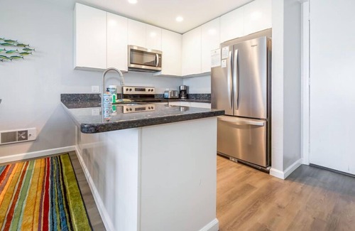 Townsite Condo | B306 - Luxury Penthouse with spacious deck. Enjoy ocean View from Deck lounge sun bed