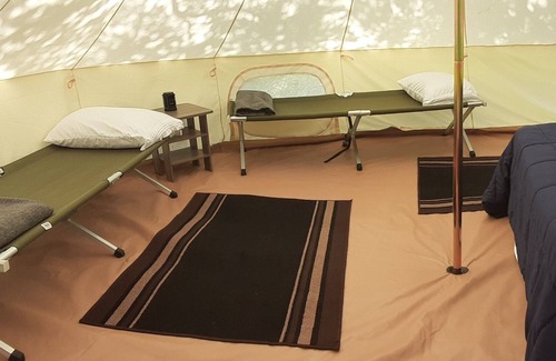 Spring Branch RV Rental | Bent Oak Glamping Tent Queen Bed, 2 Cots, Electric and AC