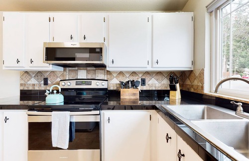 Bothell House | Charming retreat with a wood-burning fireplace, balcony, and a foosball table
