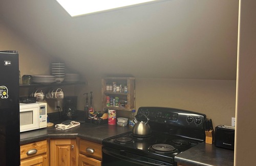 Island Park House | Enjoy the spacious vaulted ceilings with a full kitchen and open concept living!