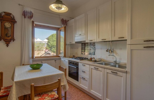 Magliano in Toscana House | Move into a functional holiday apartment with a garden and communal pool.
