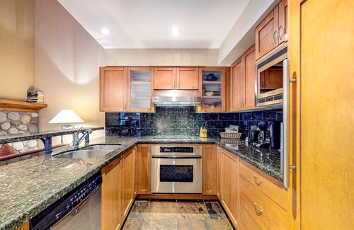 Village North House | Relaxing first-floor townhouse with a private hot tub, fireplace, & great views