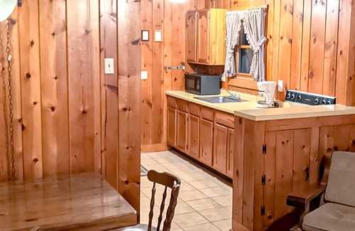 Presque Isle Cabin | Relaxing lake getaway with water views, on-site swimming, fishing, & boating