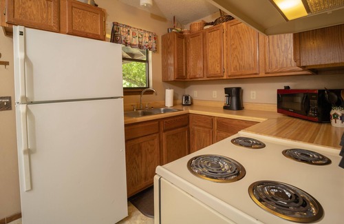Boswell Cabin | Riverfront Cabin with Bluff Views Covered Deck and Hot Tub