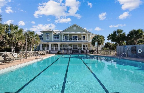 Plantation House | This sweet cottage is fenced by lush, natural landscaping and offers a peek of the Apalachicola Bay.