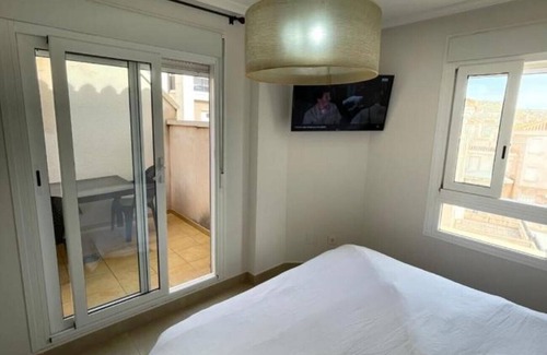 Santa Pola Villa | Villa 'Adosado Santa Pola' with Shared Pool, Wi-Fi and Air Conditioning