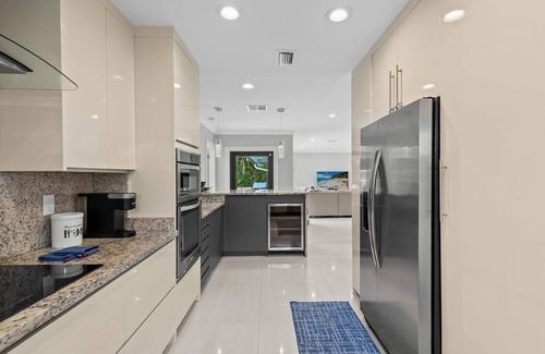 Lighthouse Point House | Waterfront~HUGE Heated Pool~Open Floor Plan~BIG Patio with Lots of Seating + Dock~Near Beaches