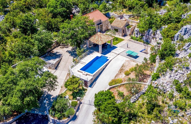 An authentic Dalmatian stone cottage on a hill, surrounded by unspoiled nature in the heart of the D