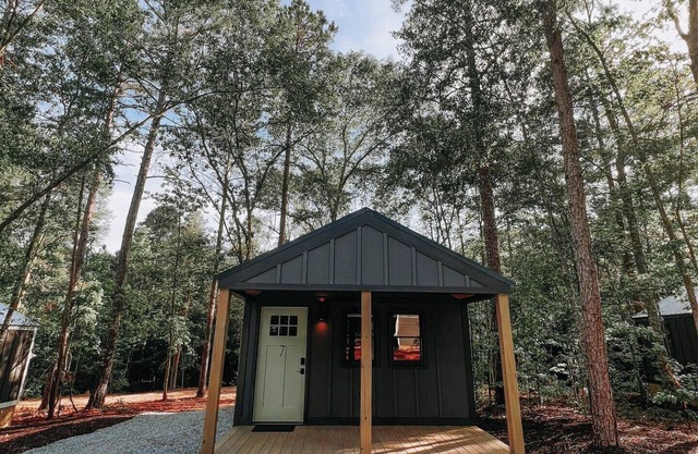 Cabin #7: One king-size bed, a kitchenette, and a large gravel parking pad beside the cabin for easy boat or trailer storage.