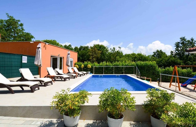 Holiday home with pool and children's playground
