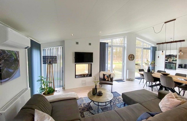 Home with modern interior with air conditioning and view of the forest.