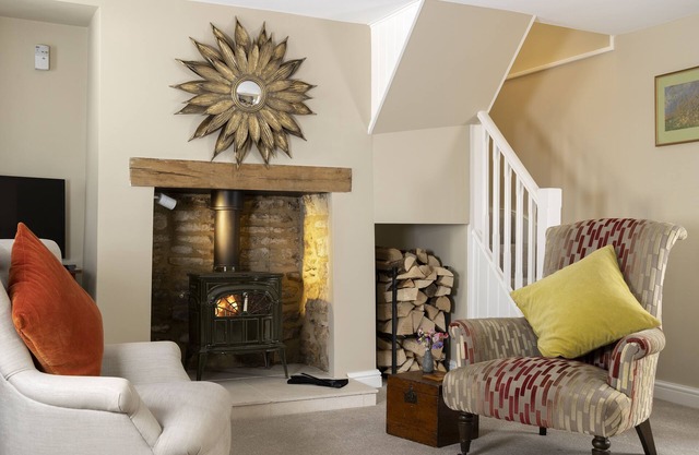 This charming Cotswold stone cottage, elegantly furnished with a seamless blend of antique and conte