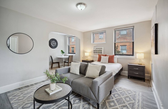 This is a studio apartment with a separate kitchen nook, and a small living nook with a loveseat