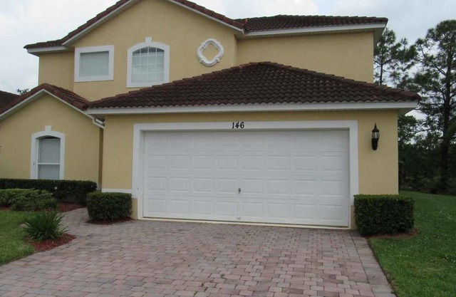 Two story, spacious 4/3 Pool Home at Lake Wilson Preserve. Backed to a conservation area for enhance