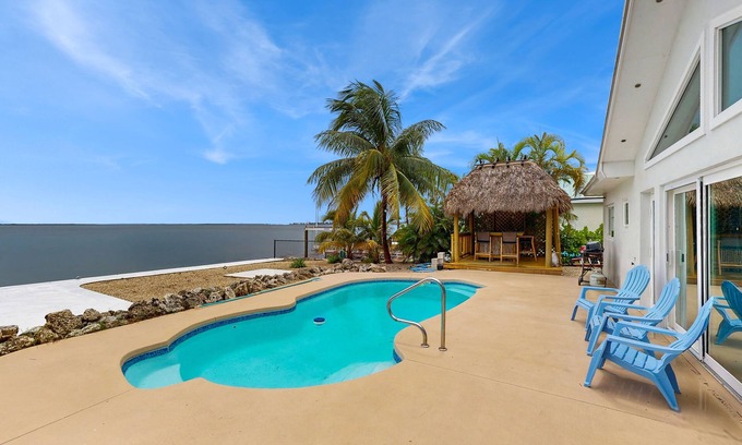 Tropical Bay Estates House | Dog-friendly home with waterfront views, a pool & Wifi