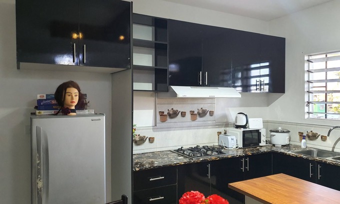 Suva Apartment | Master Bedroom with Shared Kitchen