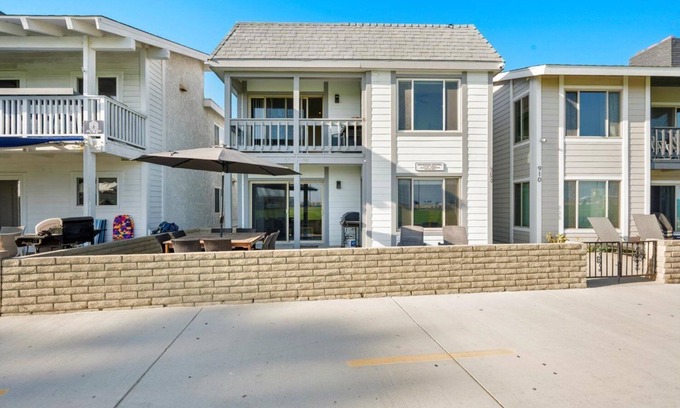 Balboa Peninsula Apartment | Oceanfront Boardwalk property, Newly remodeled Large patio, Steps to the sand.