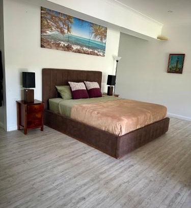 Gold Coast House | One bedroom with shared bathroom ground level of a two-story house