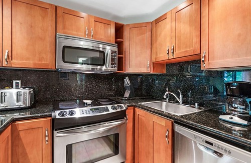 Kaanapali Condo | Maui Resort Rentals: The Whaler 124 - Luxurious Ground Floor Corner 1BR/2BA w/ Wrap-Around Balcony, Partial Ocean and West Maui Mountain Views, Large Adjacent Lawn Area