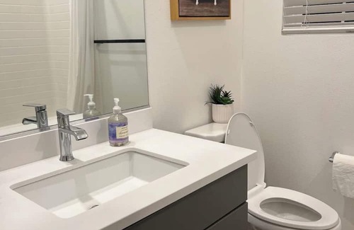 Upland House | Beautiful bedroom 02 with a private bathroom featuring a tub and shower.