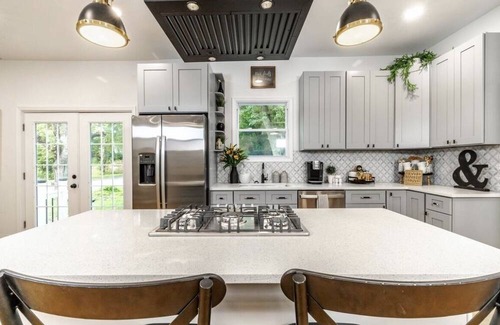 Mickleton House | Embrace the charm of our creekside haven featuring 4BR 3BA yoga and BBQ deck.