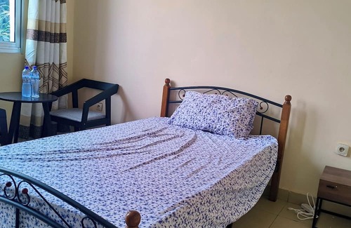 Limete House | Cozy Guest Room in Kinshasa with Balcony and Partial Air-Conditioning