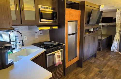 Jacob RV Rental | Camper in country setting beside water, near Burning Star Wildlife area