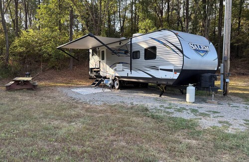 Jacob RV Rental | Camper in country setting beside water, near Burning Star Wildlife area
