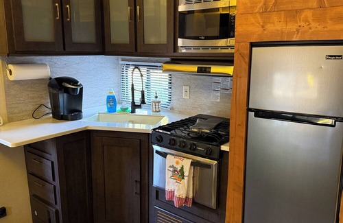 Jacob RV Rental | Camper in country setting beside water, near Burning Star Wildlife area