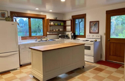 Eastsound House | Dragonfly Pond house is a rustic, spacious, light-filled vacation rental home on Orcas Island with high ceilings overlooking a tranquil pond. Clean & comfy. Located in 7 acres of forest, it's peaceful and secluded. Close to town and the ferry.