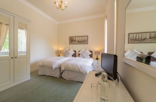 This spacious twin room, located on the first floor, boasts relaxing neutral decor,