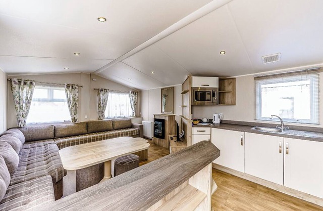 Modern and contemporary 12ft-wide caravan with one double and one twin.