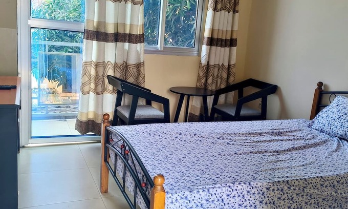 Limete House | Cozy Guest Room in Kinshasa with Balcony and Partial Air-Conditioning