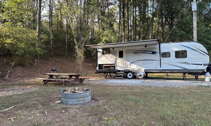 Jacob RV Rental | Camper in country setting beside water, near Burning Star Wildlife area